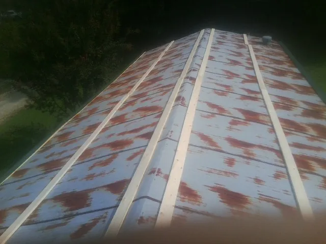 Rusted metal roof panels with new wood purlins before replacement — Storm Damage Roof Repair in Gateway by Roofing Brothers