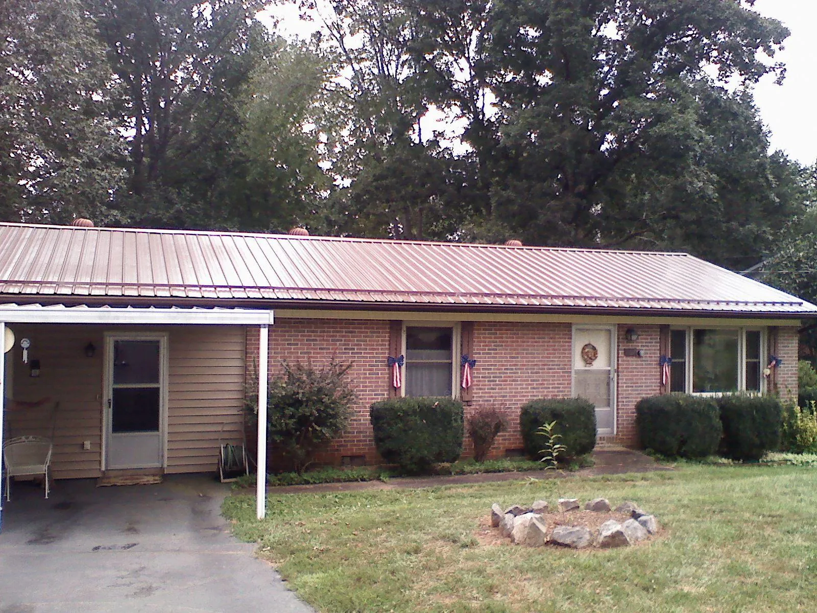 Bronze metal roof and carport on a brick ranch home — Roof Repair work by our crew in Gateway