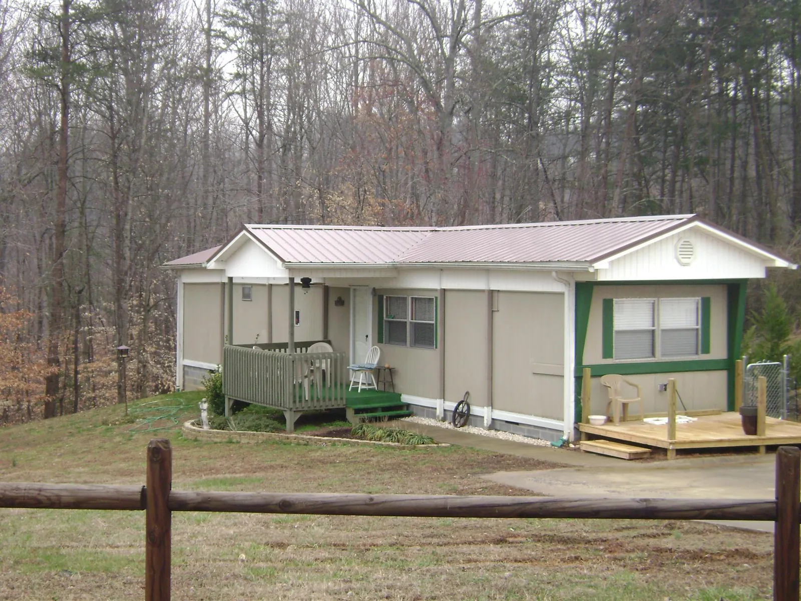 Mauve metal roof on a manufactured home with a new front deck in Gateway